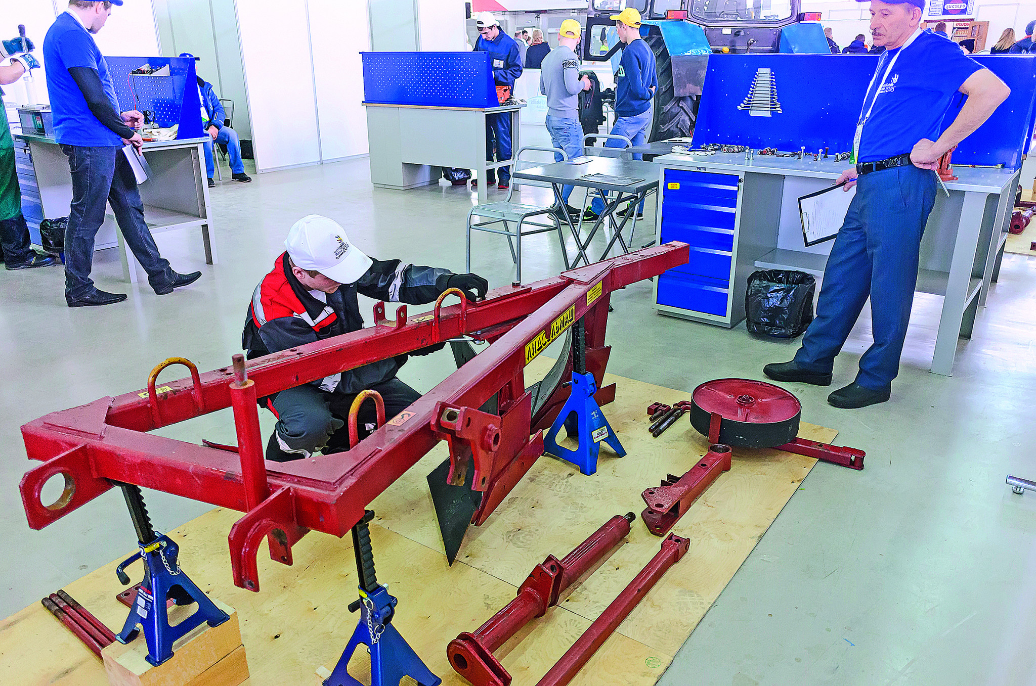 Tyumen, Russia - March 23. 2016: Open championship of professional skill among youth. Worlld skills Russia Tyumen - 2016. Young car mechanic passes competition stage and install agriculture equipment